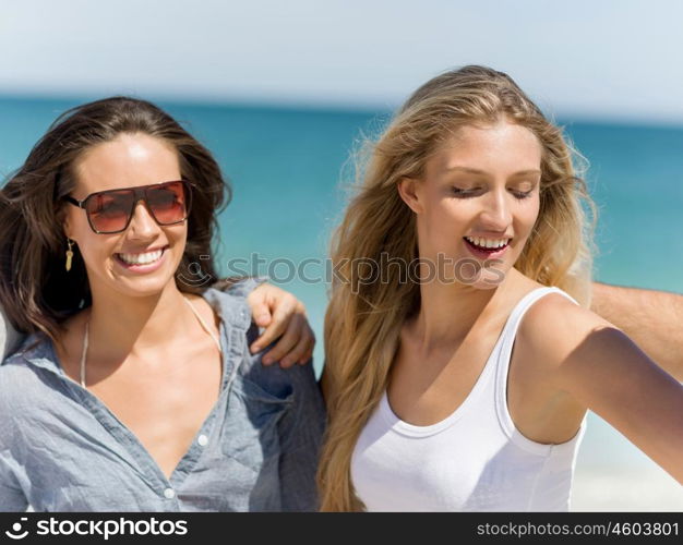 Company of young people on the beach. Company of young friends on the beach walking and having fun