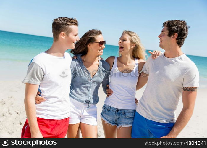 Company of young people on the beach. Company of young friends on the beach walking along the shore