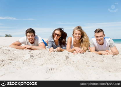 Company of young people on the beach. Company of young friends on the beach relaxing on white sand