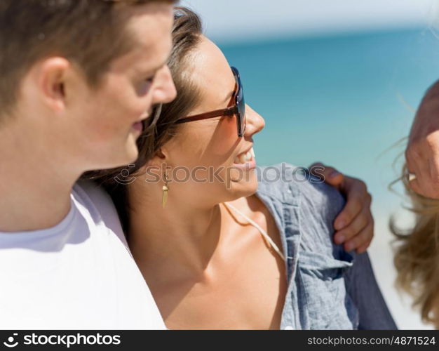 Company of young people on the beach. Company of young friends on the beach walking and having fun