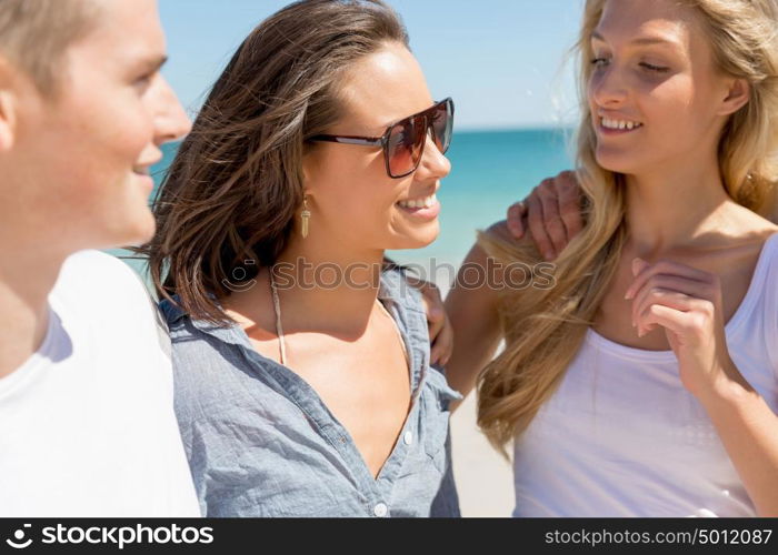 Company of young people on the beach. Company of young friends on the beach walking along the shore