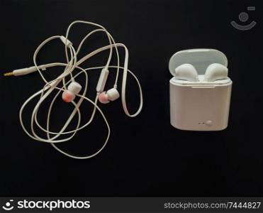 Comparison between tangled wired headphones versus wireless earphones for music listening. Pros and cons, opposite contrary. Technology development tendencies, human entertainment conveniences concept