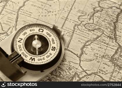 Compass and old map. Processing of a antique photo