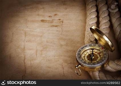 Compass and rope on the old paper background
