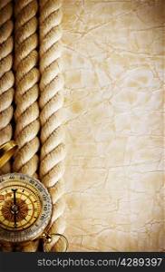 Compass and rope on vintage old paper background