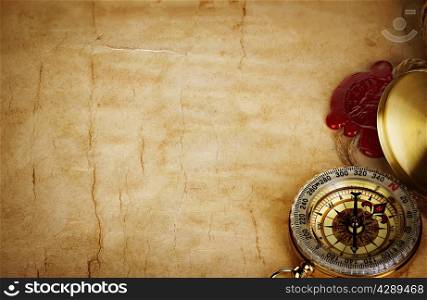 Compass and scroll with wax seal on vintage old paper background