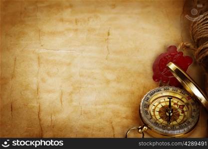 Compass and scroll with wax seal on vintage old paper background