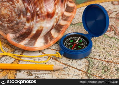 compass and seashell on the map