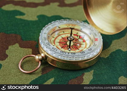 Compass on a camouflage background