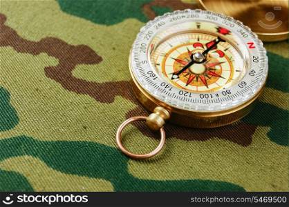 Compass on a camouflage background