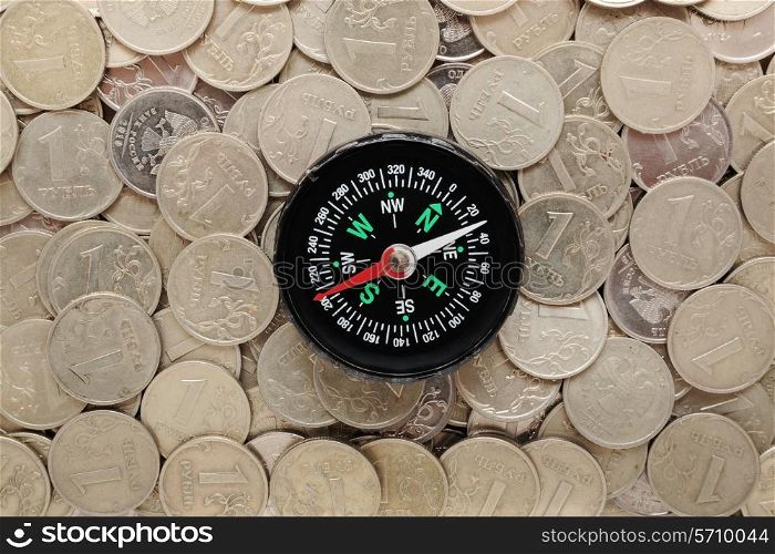 compass on a heap of coins