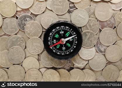 compass on a heap of coins