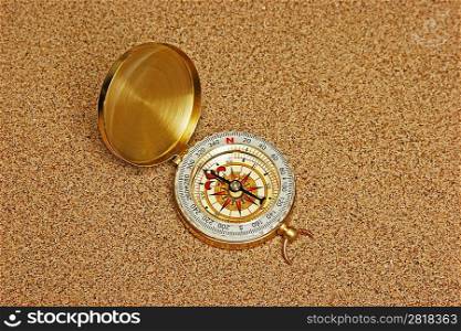 compass on a sandy beach