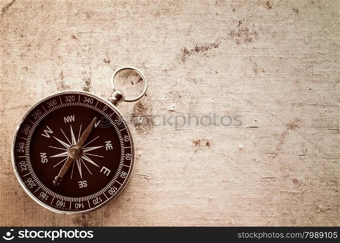 Compass on old canvas texture with copy-space