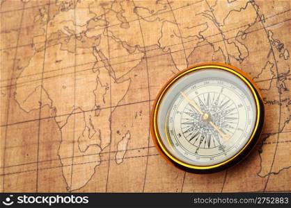 Compass on old map. Gold comapss and yellow map