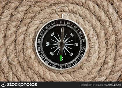 compass on old twisted rope