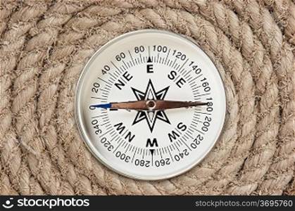 compass on old twisted rope