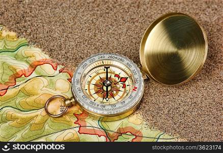 compass on the map with sand