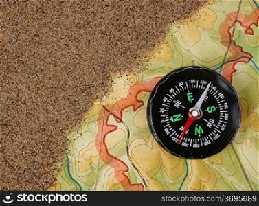 compass on the map with sand