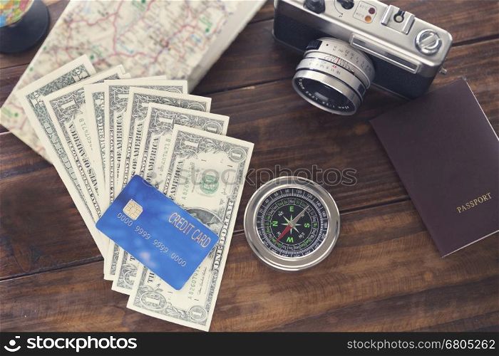 compass, passport, credit card, banknote, camera,map for use as trip vacation concept (vintage tone and selected focus)
