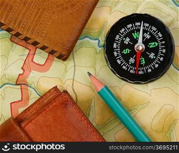 compass wallet and passport on the old map