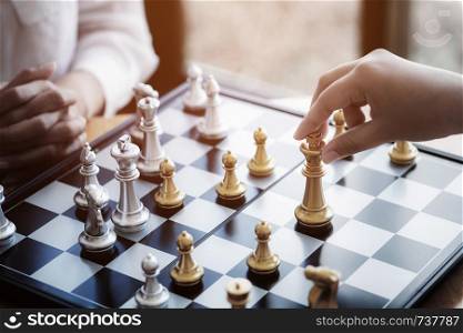 Competition and Challenge Concept, Two businesspeople playing chess board.