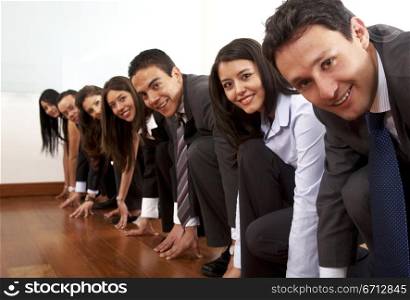 competitive business people in an office lining up for a race