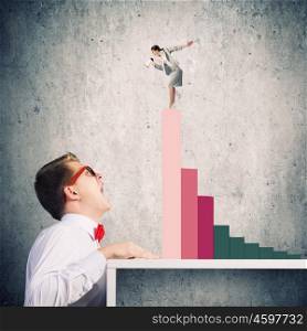 Competitive concept. Businessman screaming at businesswoman standing on top of graph