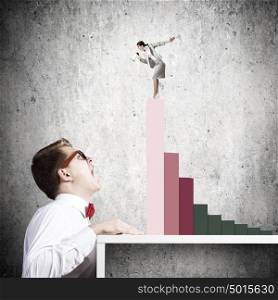 Competitive concept. Businessman screaming at businesswoman standing on top of graph