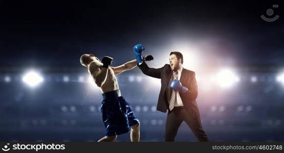 Competitive spirit in business. Businessman in suit fighting opponent at ring