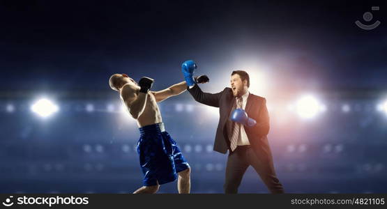 Competitive spirit in business. Businessman in suit fighting opponent at ring