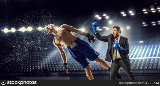 Competitive spirit in business. Businessman in suit fighting opponent at ring
