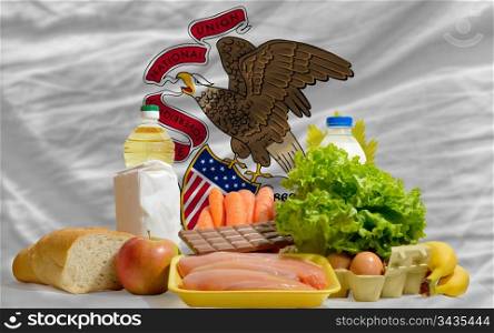 complete american state flag of illinois covers whole frame, waved, crunched and very natural looking. In front plan are fundamental food ingredients for consumers, symbolizing consumerism an human needs