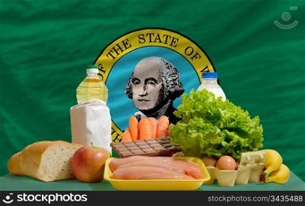 complete american state flag of washington covers whole frame, waved, crunched and very natural looking. In front plan are fundamental food ingredients for consumers, symbolizing consumerism an human needs