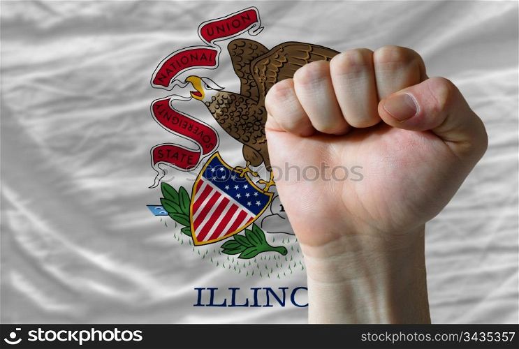 complete american state of illinois flag covers whole frame, waved, crunched and very natural looking. In front plan is clenched fist symbolizing determination