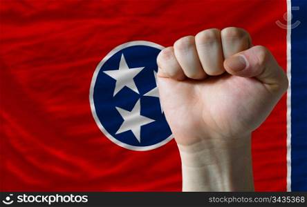 complete american state of tennessee covers whole frame, waved, crunched and very natural looking. In front plan is clenched fist symbolizing determination
