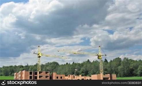 complete construction time-lapse from start to finish on background of cloudy sky near forest, wide angle