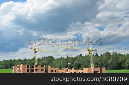 Complete construction time-lapse from start to finish on background of cloudy sky near forest. Original color and design changed, wide angle, 1080p