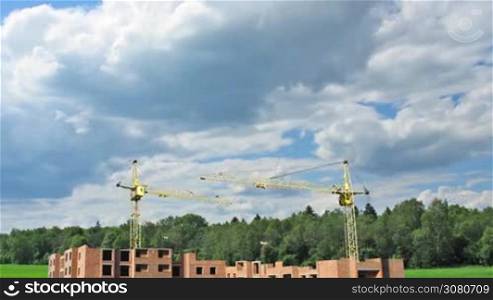 Complete construction time-lapse from start to finish on background of cloudy sky near forest. Original color and design changed, wide angle, 1080p