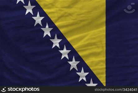complete national flag of bosnia herzegovina covers whole frame, waved, crunched and very natural looking. It is perfect for background