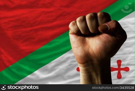 complete national flag of katanga covers whole frame, waved, crunched and very natural looking. In front plan is clenched fist symbolizing determination