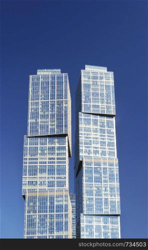 Complex City of Capitals (St. Petersburg Tower - left, Moscow Tower - right) in Moscow International Business Center (Moscow-City). Moscow, Russia. Blue sky background.