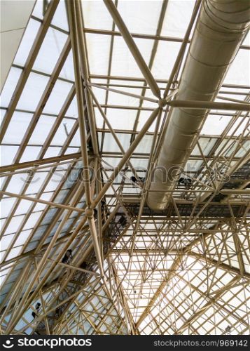 Complex truss frame of the ceiling on the top of the shopping mall with the maintenance path.