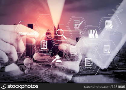 Compliance Virtual Diagram for regulations, law, standards, requirements and audit.businessman hand working with smart phone and laptop and digital tablet computer in modern office.