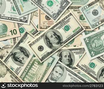 Composite shot of different American Dollar bills piled together.