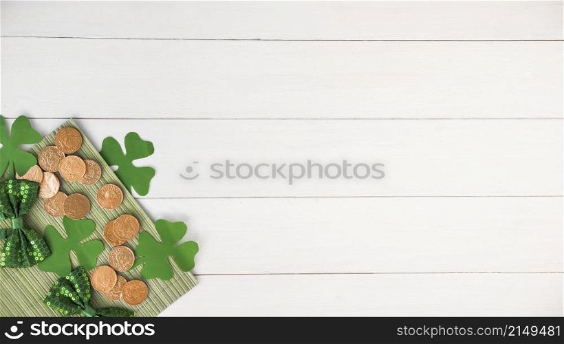 composition bow ties near coins green paper clovers board