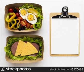 composition different meals with empty clipboard