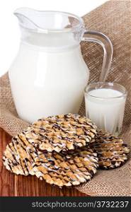 Composition milk in a jug, a glass on burlap background