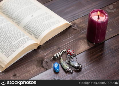 Composition of esoteric objects,candle and book used for healing and fortune-telling.