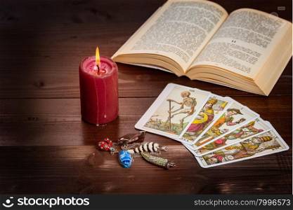 Composition of esoteric objects,candle,Tarots and book used for healing and fortune-telling.